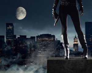 Sexy Female thief with gun, new york on background